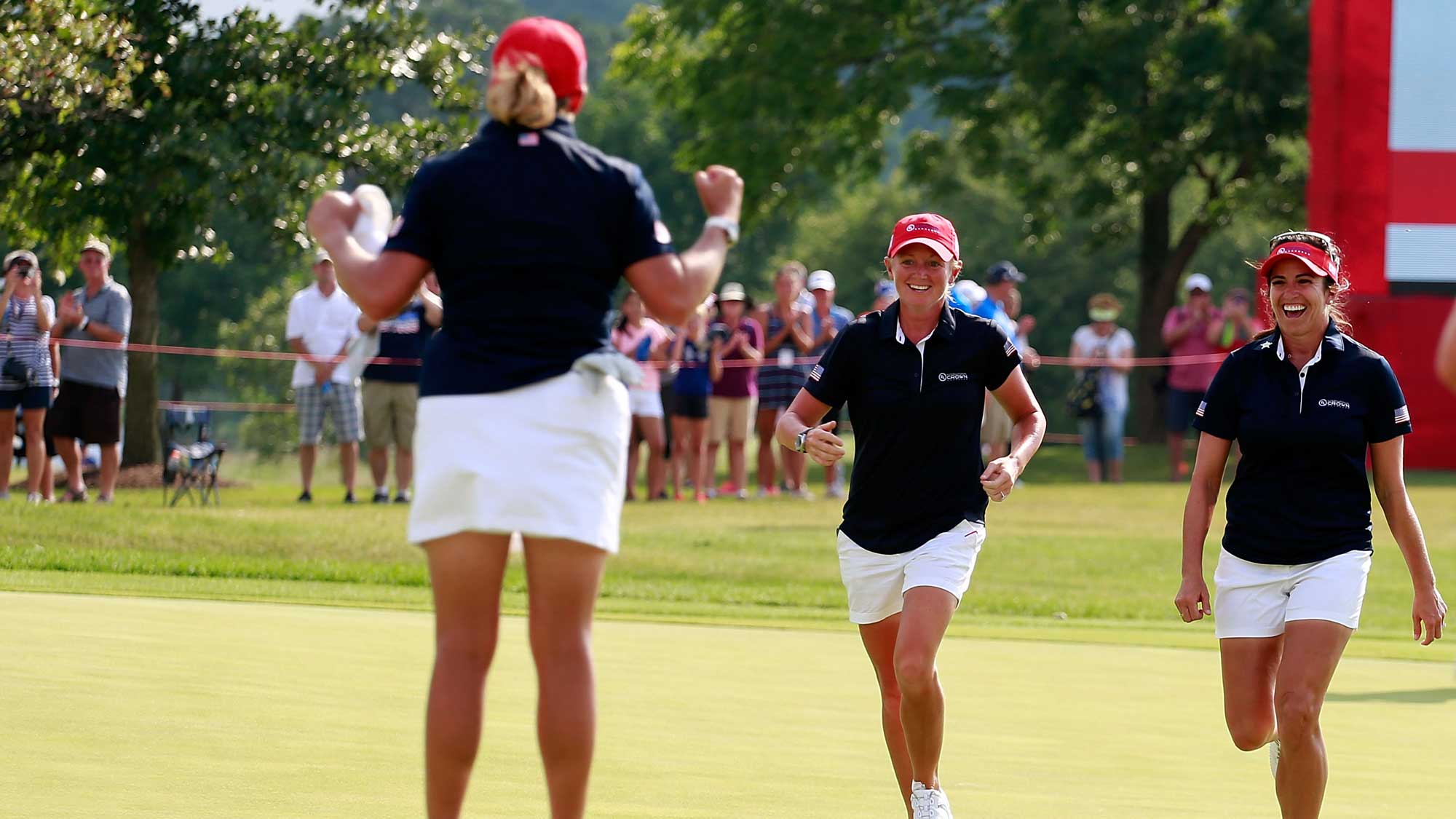 (L-R) Cristie Kerr celebrates with Stacy Lewis and Gerina Piller of the United States after winning her singles matches of the 2016 UL International Crown