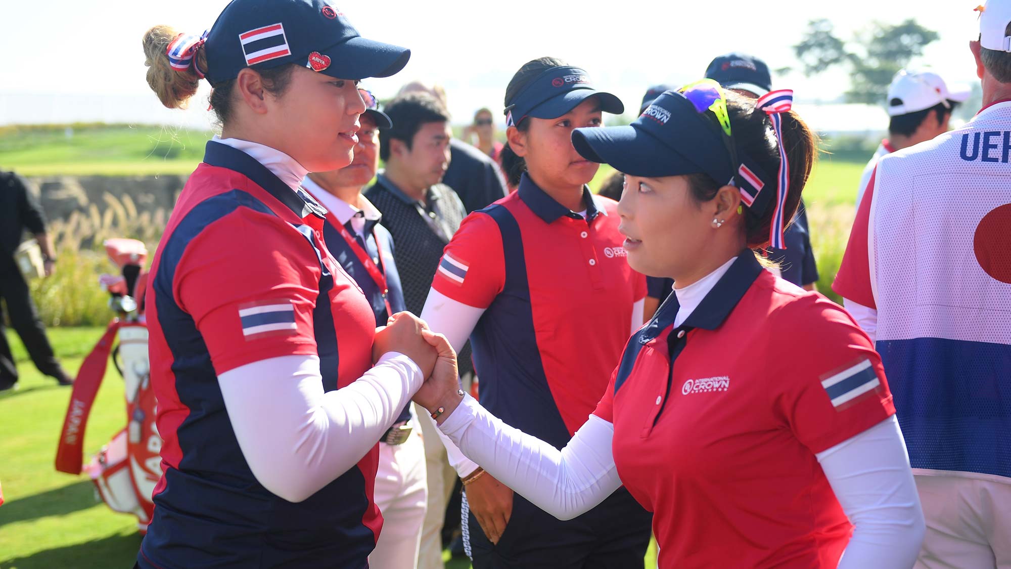 Ariya Jutanugarn (L) and Moriya Jutanugarn (R) of Thailand shake hands prior to the Pool B match between Japan and Thailand on day one of the UL International Crown