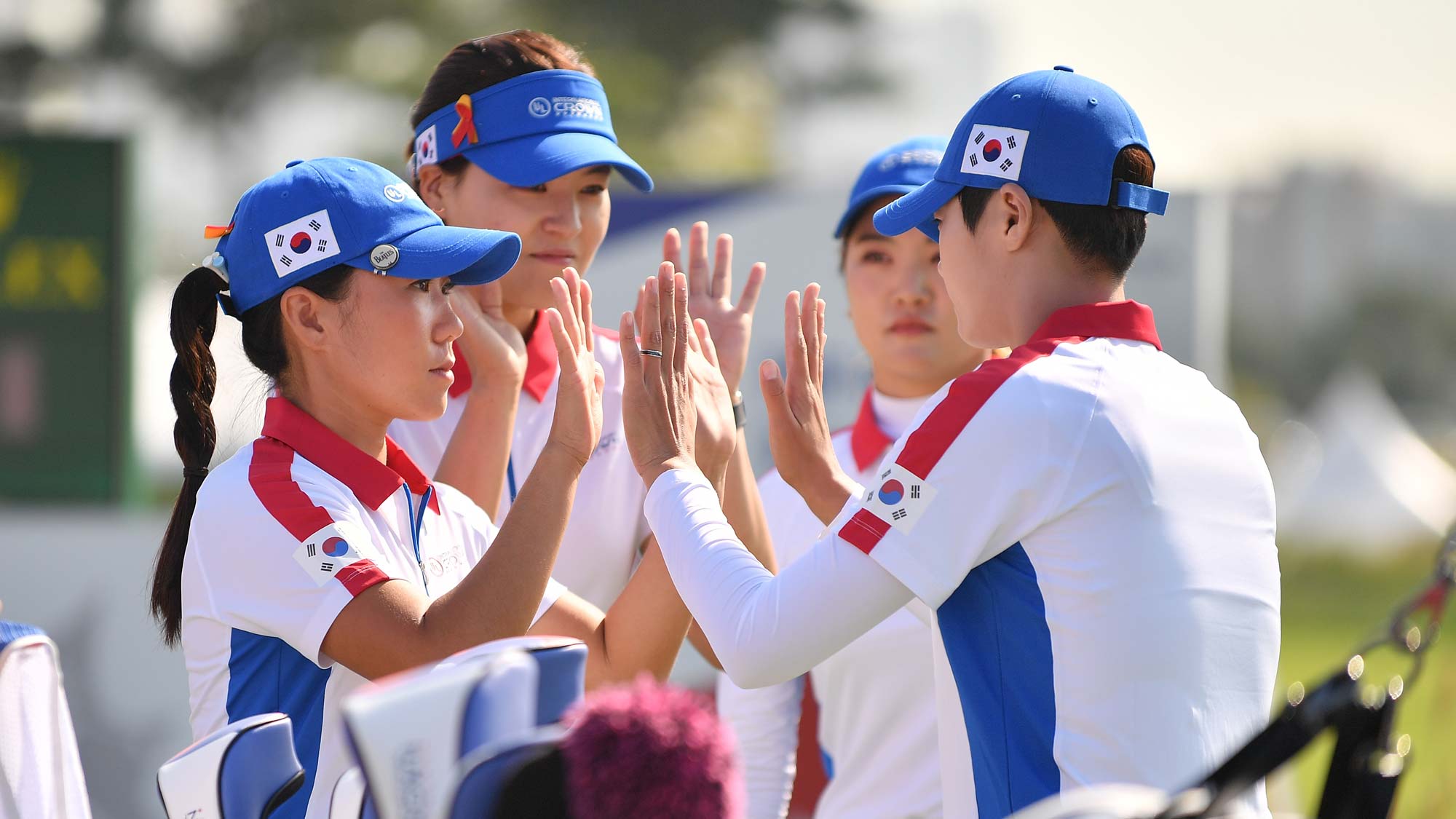 South Korean players high five prior to the Pool A match between South Korea and Chinese Taipei on day one of the UL International Crown