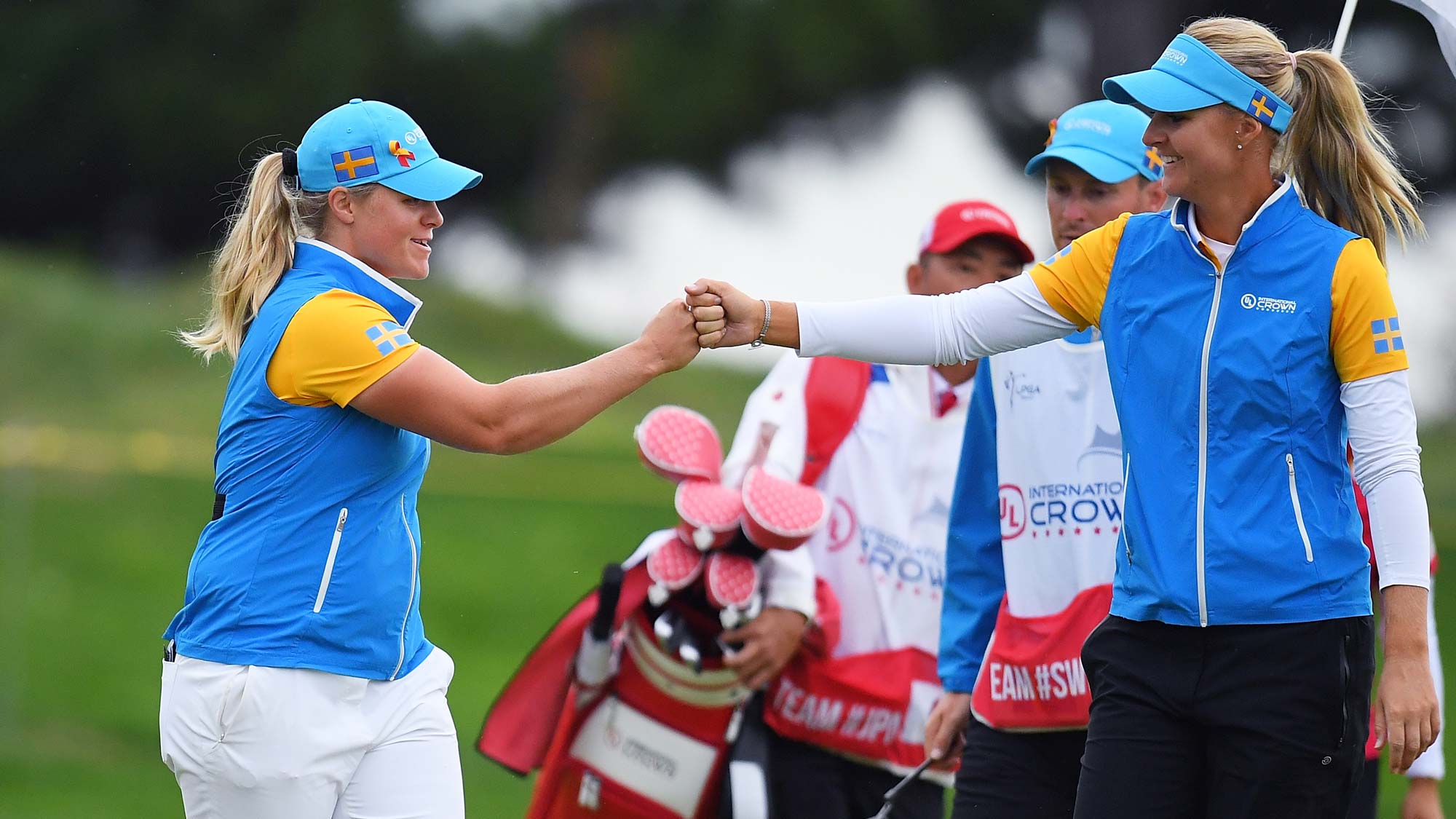 Caroline Hedwall (L) of Sweden celebrates with Anna Nordqvist (R) after her birdie on the 2nd green in the Pool B match between Japan and Sweden on day two of the UL International Crown