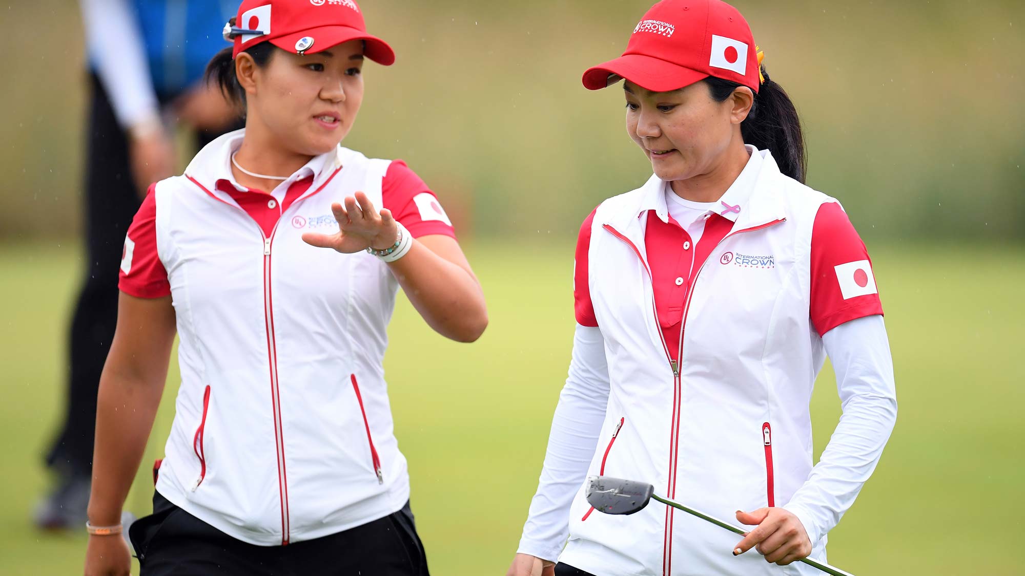Nasa Hataoka (L) and Ayako Uehara (R) of Japan talk on the 4th green in the Pool B match between Japan and Sweden on day two of the UL International Crown
