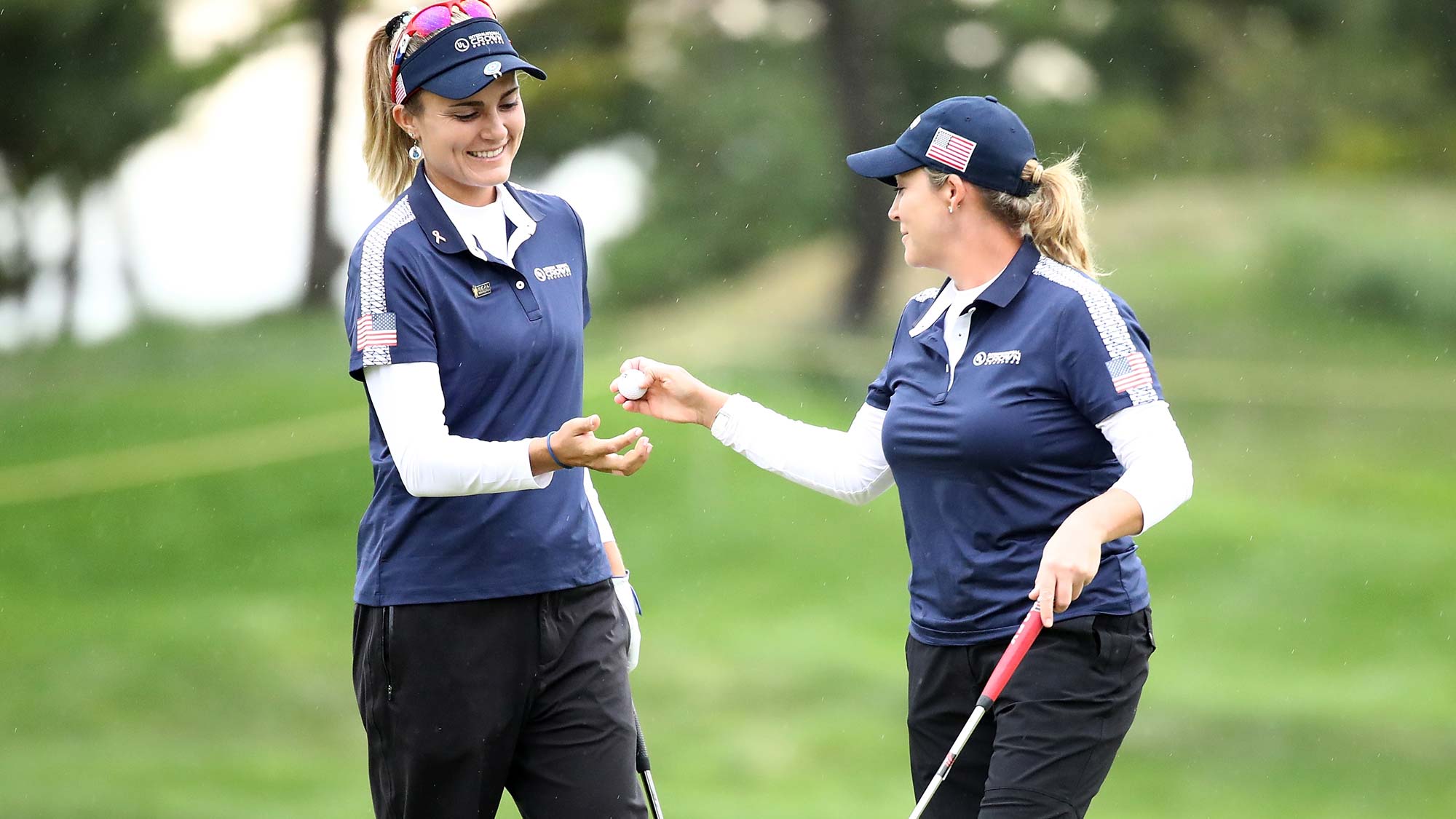 Lexi Thompson (L) and Cristie Kerr (R) of the United States celebrate on the 2nd green during the Pool B match between USA and Thailand on day two of the UL International Crown