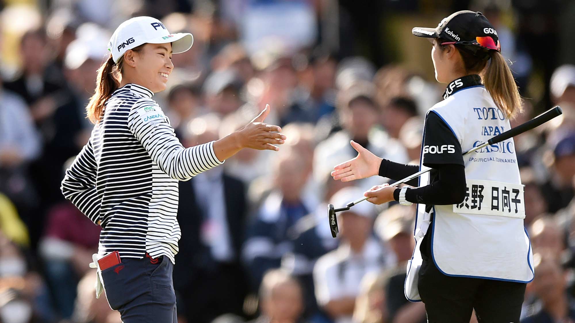 Hinako Shibuno smiles alongside caddy